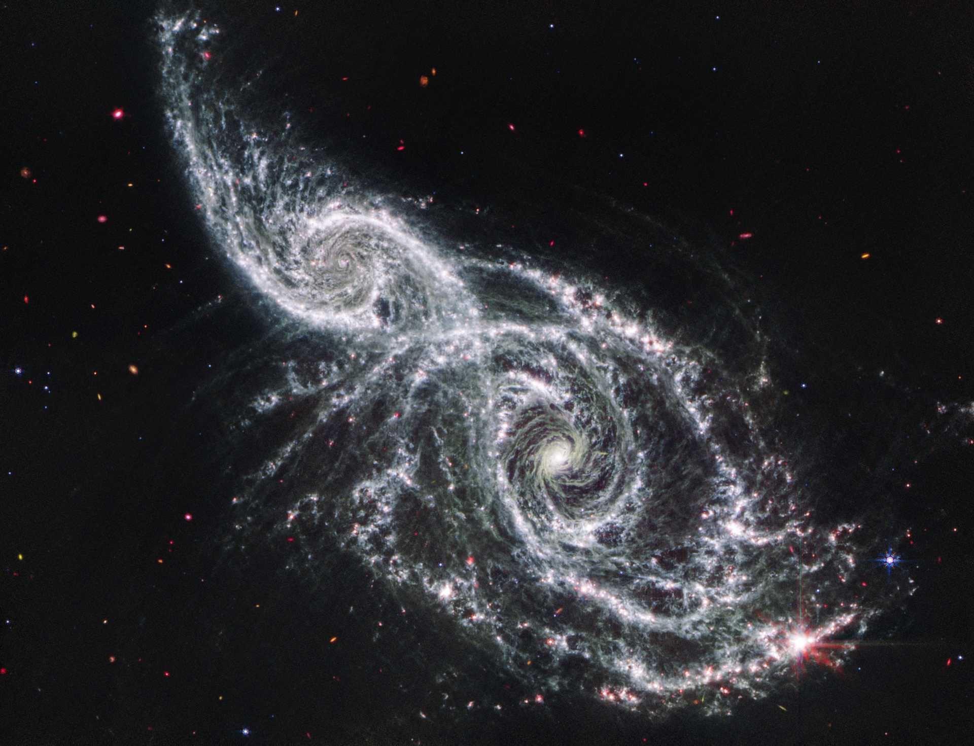 Photo of galaxies IC 2163 and NGC 2207 by the James Webb Space Telescope. Distance from earth: approximately 81 +/- 39 million lightyears