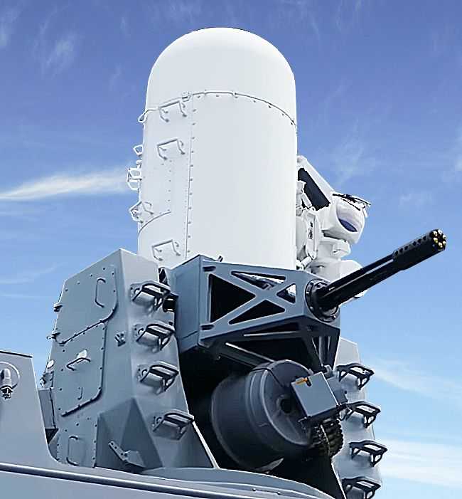 The Phalanx defensive system. The grey barrel is pointing out of the picture, a large white ammunition container can be seen at the top.  
