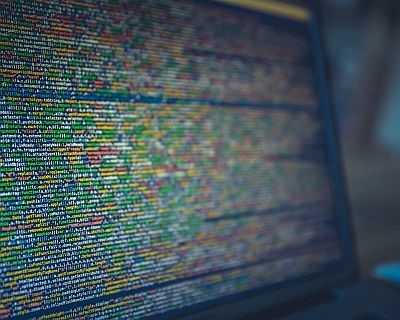 Image of a screen with colour-coded but illegible software code